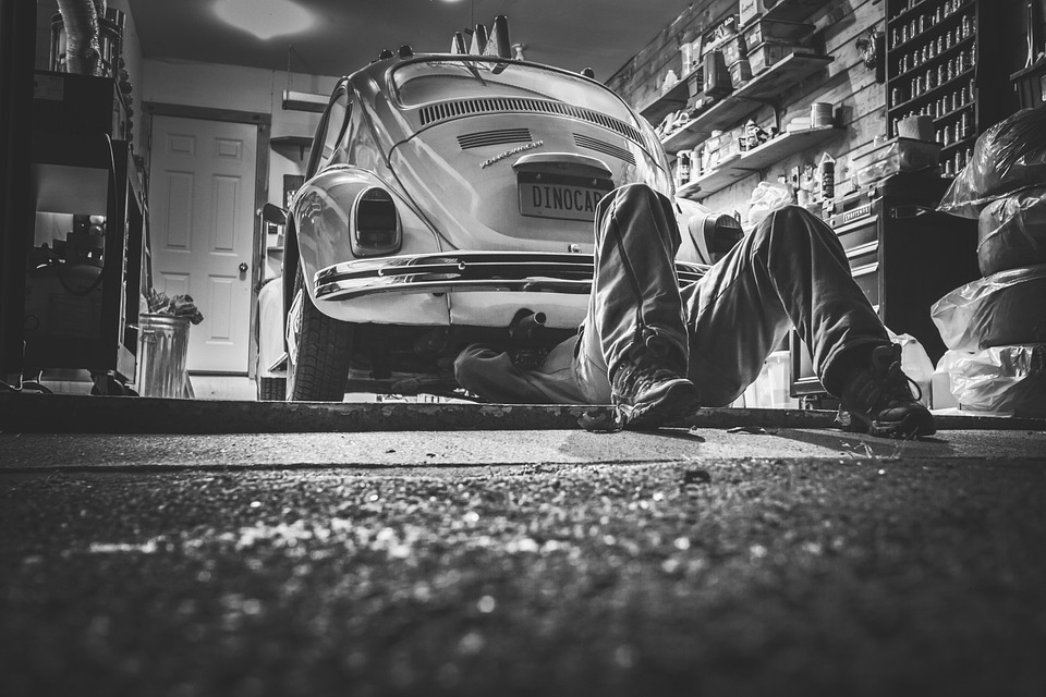 man doing a repair on his beetle car